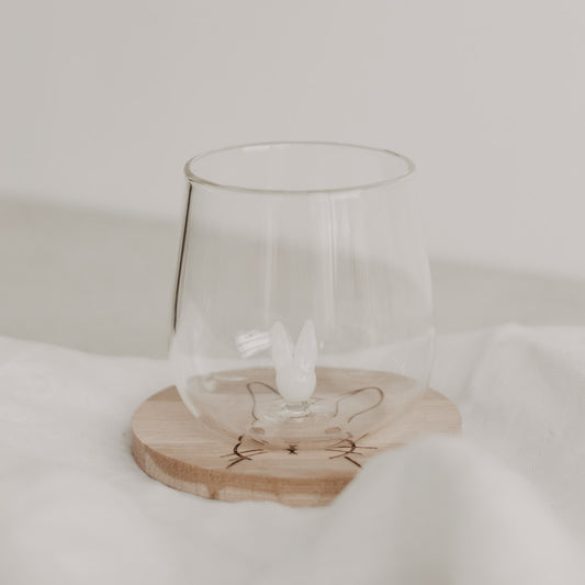 Figurglas Hase mit Hasenfigur im Glasinneren auf rundem Holzuntersetzer mit Hasenzeichnung