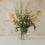 Glasvase mit schwarzen Herzen und vollem Blumenarrangement