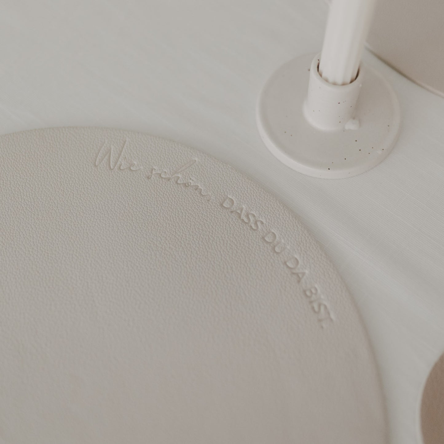 Detailaufnahme des Platzsets in Creme mit Schriftzug „Wie schön, dass du da bist“.