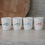 Vier weiße Keramikbecher „breakfast club“ mit farbigen Schriftzügen, minimalistisch arrangiert