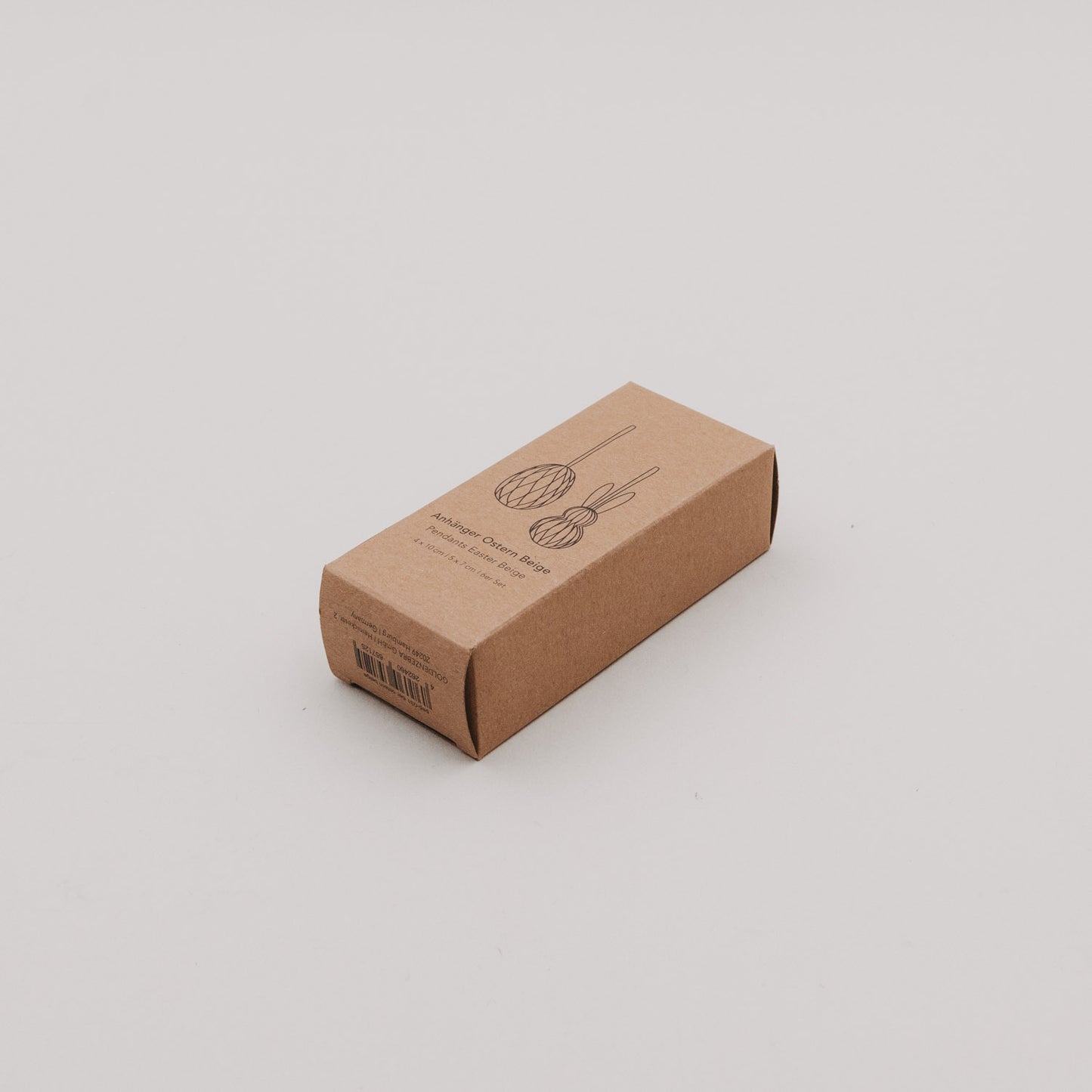Kartonverpackung der beigen Papieranhänger in Ei- und Hasenform.