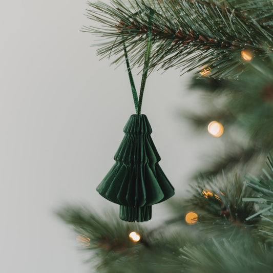 Grüne Papiertanne als Weihnachtsanhänger mit Faltoptik am Tannenzweig