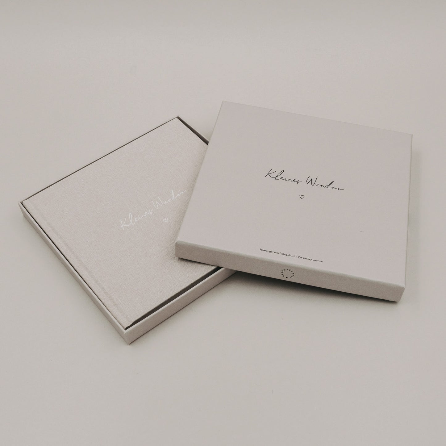 Schwangerschaftstagebuch „Kleines Wunder“ in eleganter Geschenkbox auf hellem Hintergrund.